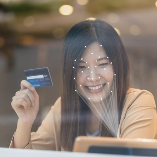 Asian women using the technology tablet for access control by face recognition in private identification step when online shopping with the credit card, credit card mockup, online payment concept,